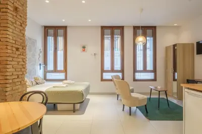 a bedroom with a bed and a table and chairs at Gorgeous Apartment close to City Centre in Valencia