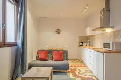a living room with a couch and a kitchen at Apt with Antique Floor & lots of Sun Light in Valencia