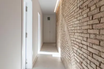 an empty hallway with a brick wall at Apt with Antique Floor & lots of Sun Light in Valencia
