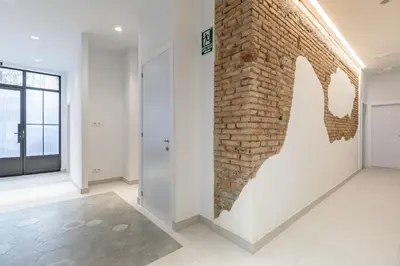 an empty room with a brick wall and a door at Apt with Antique Floor & lots of Sun Light in Valencia