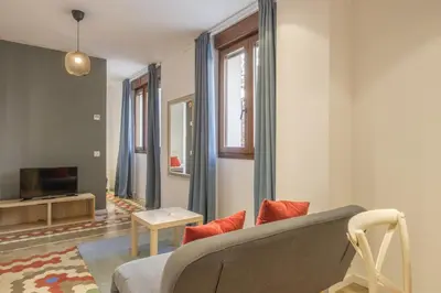 a living room with a couch and a tv at Apt with Antique Floor & lots of Sun Light in Valencia