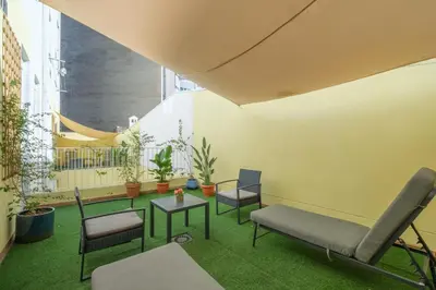 a room with chairs and a table and plants at Marvellous Apt with a Large Private Terrace in Valencia