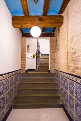 a staircase in an old building with a blue ceiling at Old Town Plaza Negrito by Nomad Host in Valencia