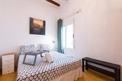 a small bedroom with a bed and a table at Old Town Plaza Negrito by Nomad Host in Valencia