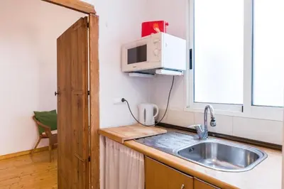 a kitchen with a sink and a microwave at Old Town Plaza Negrito by Nomad Host in Valencia