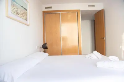 two white beds in a room with a closet at VLC HOST - Cuber in Valencia