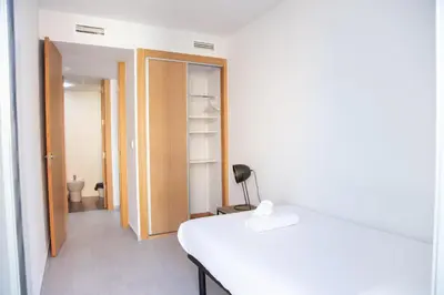 a bedroom with a white bed and a closet at VLC HOST - Cuber in Valencia