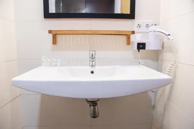a white sink in a bathroom with a mirror at VLC HOST - Cuber in Valencia