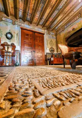 a room with a stone floor and a wooden door at CASA BAUTISTA TURIS in Turís
