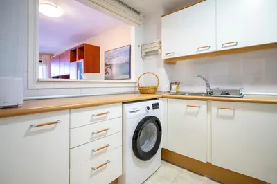 a kitchen with a washing machine and a sink at ESPACIO 16 - Primera LINEA PLAYA in Cullera