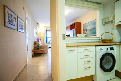 a kitchen with a washing machine in a room at ESPACIO 16 - Primera LINEA PLAYA in Cullera