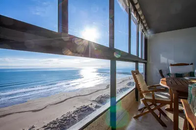 a dining room with a view of the beach at ESPACIO 16 - Primera LINEA PLAYA in Cullera