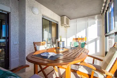 a wooden table in a room with a dining room at ESPACIO 16 - Primera LINEA PLAYA in Cullera