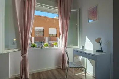 a room with a desk and a window with a desk and a chair at Modern, Stylish Apartment in Valencia