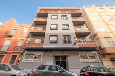 a tall building with cars parked in front of it at Modern, Stylish Apartment in Valencia