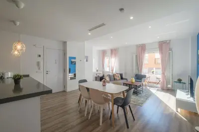 a living room and kitchen with a couch and a table at Modern, Stylish & Comfortable Apartment in Valencia