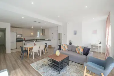 a living room with a couch and a table and chairs at Modern, Stylish & Comfortable Apartment in Valencia
