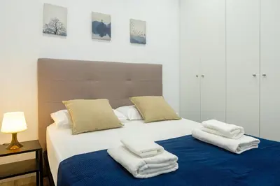 a bedroom with a bed with towels on it at Apartment With Super Comfortable Beds in Valencia