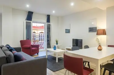 a living room with a couch and a table and chairs at Apartment With Super Comfortable Beds in Valencia