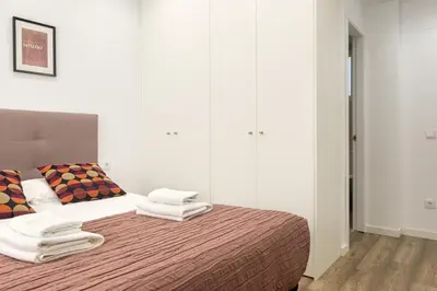 a bedroom with a bed with towels on it at Clean & Very Comfortable Apartment in Valencia