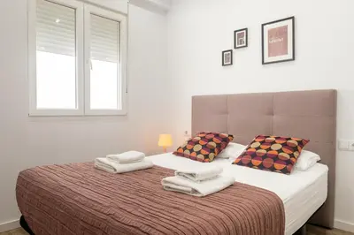 a bedroom with a large bed with towels on it at Clean & Very Comfortable Apartment in Valencia