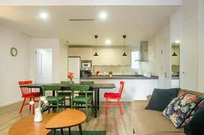 a living room and kitchen with a table and chairs at Clean & Very Comfortable Apartment in Valencia