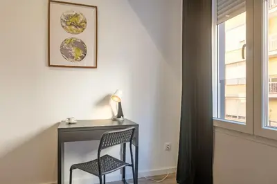 a desk with a chair next to a window at Clean & Very Comfortable Apartment in Valencia