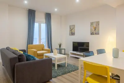 a living room with a couch and a table at Bright, Brand new & Very Comfortable Apartment in Valencia