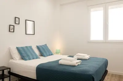 a bedroom with a bed with towels on it at Bright, Brand new & Very Comfortable Apartment in Valencia