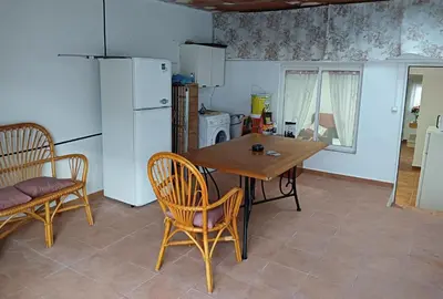 a kitchen with a table and chairs and a refrigerator at Apartamento Casa Quiles in Losa del Obispo