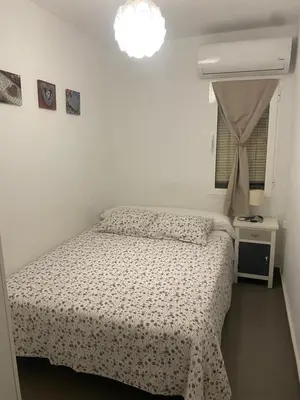 a bedroom with a bed and a window at Apartamento Casa Quiles in Losa del Obispo