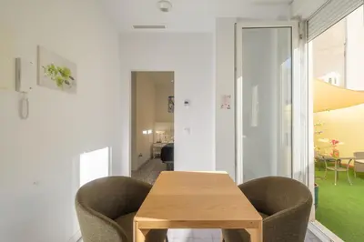 a dining room with a wooden table and two chairs at Gorgeous Apt with a Large Private Terrace in Valencia