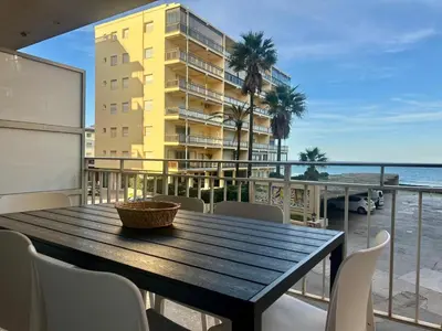 a table on a balcony with a view of the beach at Large Apartment with Sea Views in Sueca