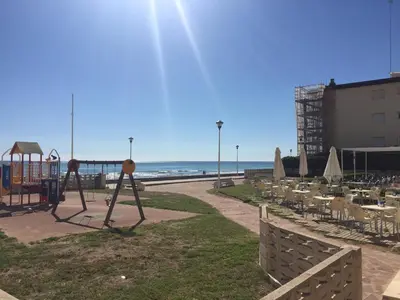 a park with a playground next to the beach at Large Apartment with Sea Views in Sueca