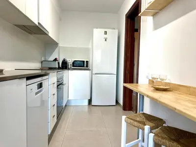 a kitchen with a white refrigerator and a counter at Large Apartment with Sea Views in Sueca