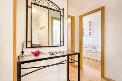 a bathroom with a mirror and a glass table at Balcón del Mar in Canet de Berenguer