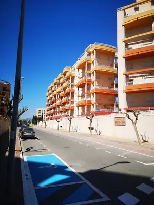 a car driving down a street next to a building at Balcón del Mar in Canet de Berenguer
