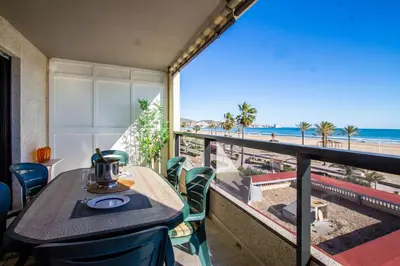 a balcony with a table and a view of the beach at ESPACIO 2 Primera LINEA DE PLAYA in Cullera