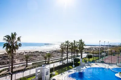 a view of the beach from the balcony of a resort at ESPACIO 2 Primera LINEA DE PLAYA in Cullera