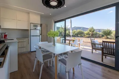 a kitchen and dining room with a table and chairs at Casa Rural Espadan Suites in Artana