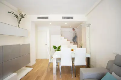 a dining room with a white table and white chairs at SingularStays Comedias IV in Valencia