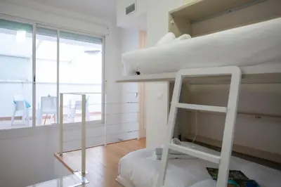 a bedroom with two bunk beds and a window at SingularStays Comedias IV in Valencia