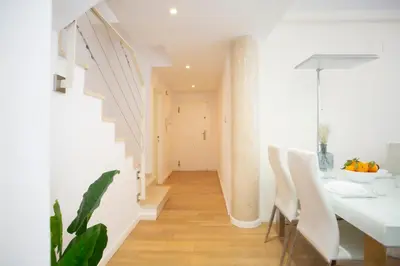 a white hallway with a white table and chairs at SingularStays Comedias IV in Valencia