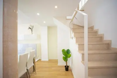 a staircase in a house with a potted plant at SingularStays Comedias IV in Valencia