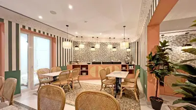a restaurant with tables and chairs in a room at Soho Boutique Turia in Valencia