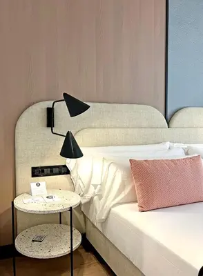 a bedroom with a bed and a table with a lamp at Soho Boutique Turia in Valencia