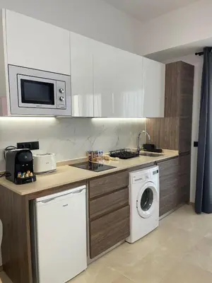 a kitchen with a washing machine and a microwave at Travel Habitat La Marina Real in Valencia