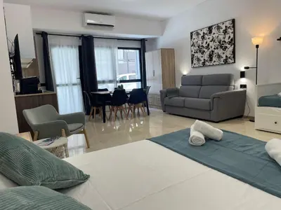 a room with a bed and a living room at Travel Habitat La Marina Real in Valencia