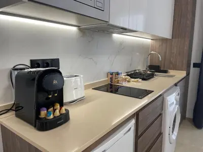 a kitchen with a counter with a coffee maker on it at Travel Habitat La Marina Real in Valencia