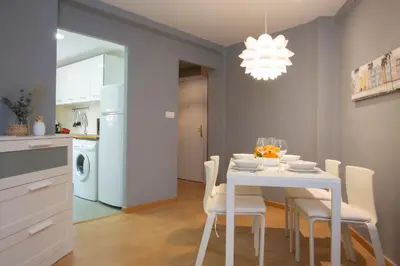 a kitchen and dining room with a white table and chairs at SingularStays Baleares in Valencia